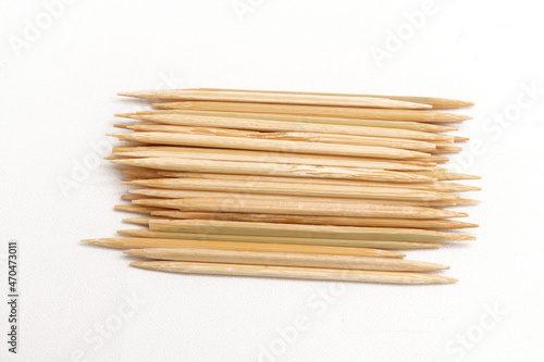 Pile of toothpicks on a white background. A tool for cleaning food residue on teeth.