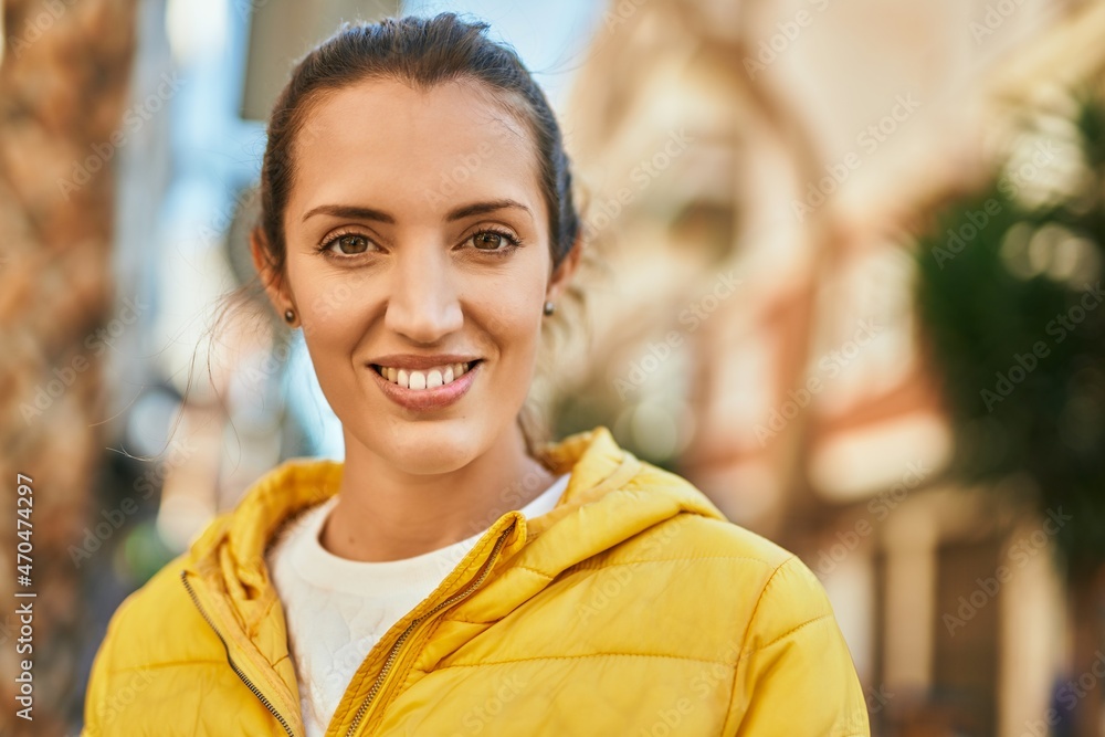 Young hispanic girl smiling happy standing at the city.