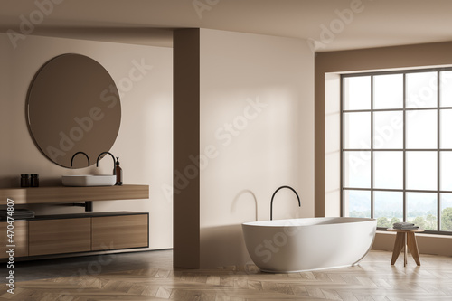 Modern beige bathroom with floor to ceiling window