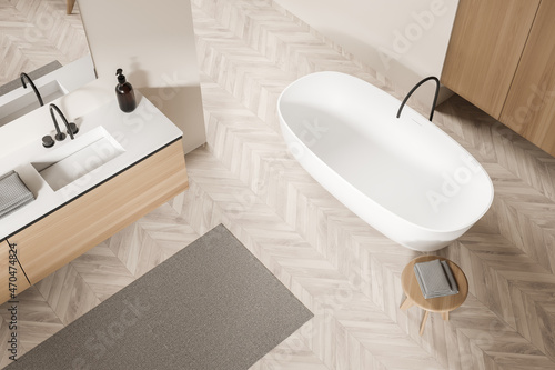 Top view of light bathroom interior with sink and mirror  tub and table