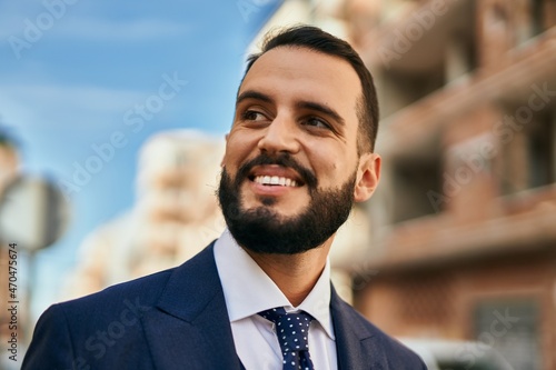 Young businessman smiling happy standing at the city.