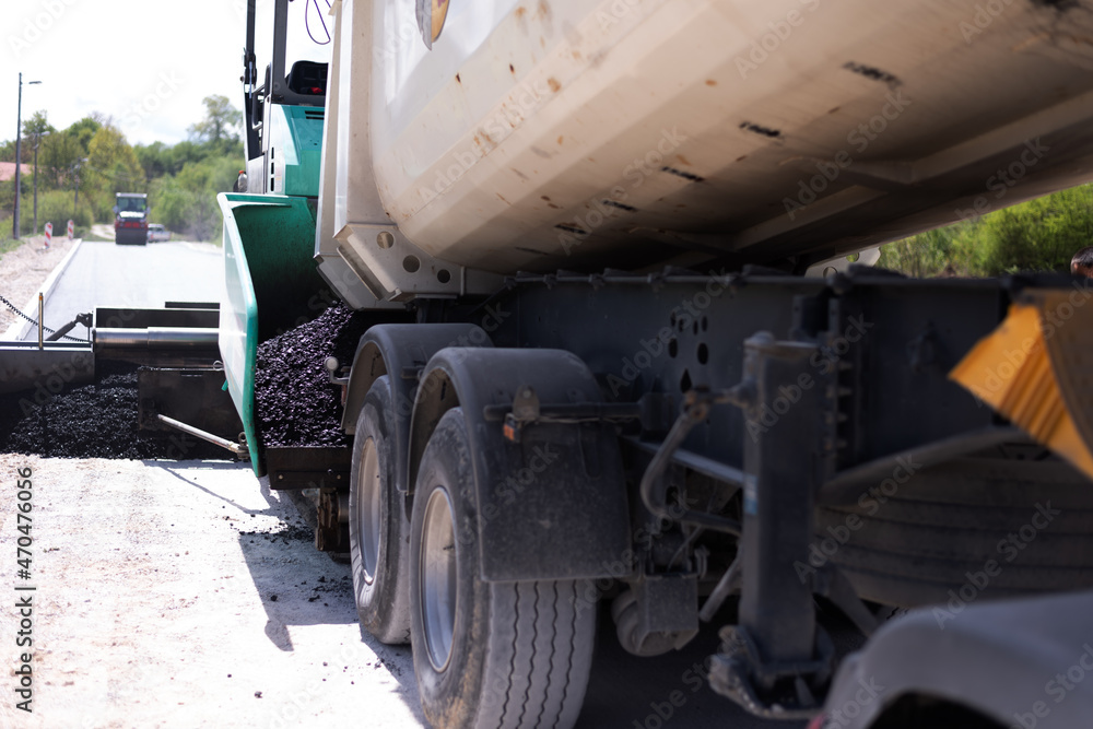 Urban road asphalting works. Asphalt paving. Paver machine and road roller. New road construction. Urban road asphalting works. Asphalt paving. Paver machine and road roller. New road construction.