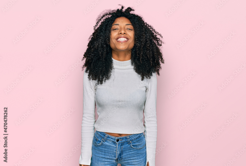 Young african american girl wearing casual clothes with a happy and cool smile on face. lucky person. Young african american girl wearing casual clothes with a happy and cool smile on face. lucky person.