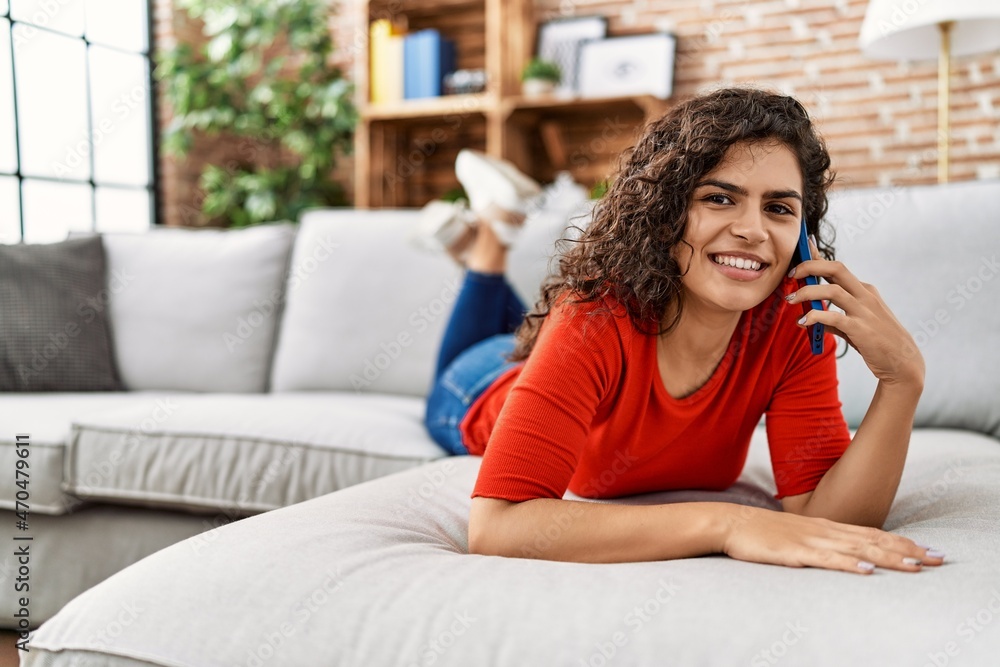 Young latin woman smiling confident talking on the smartphone at home Young latin woman smiling confident talking on the smartphone at home