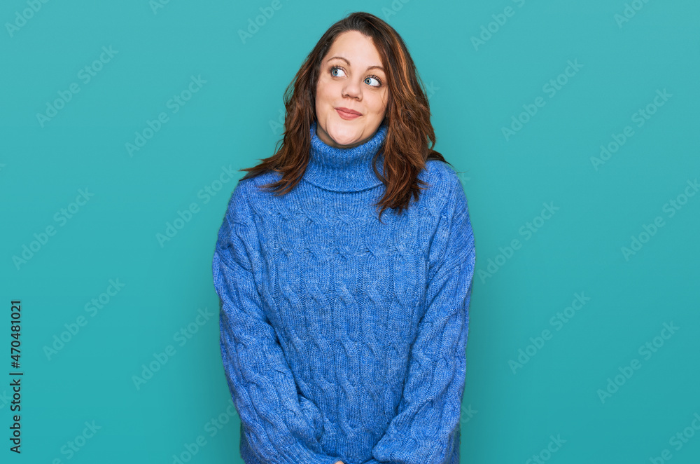 Fototapeta premium Young plus size woman wearing casual clothes smiling looking to the side and staring away thinking.