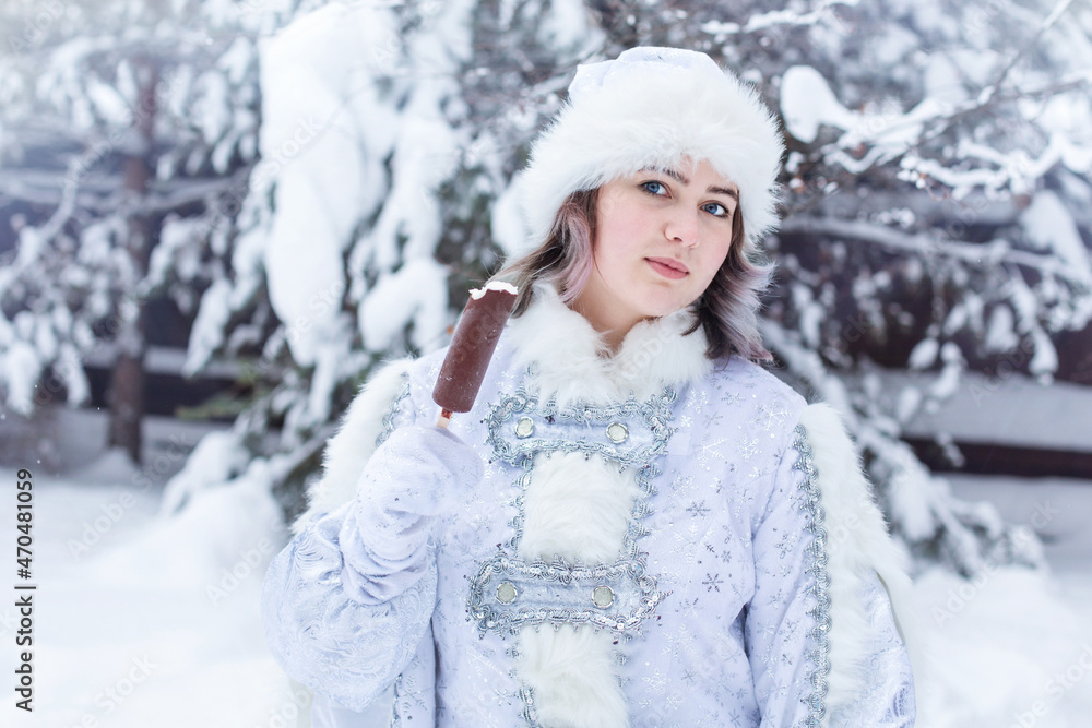 Girl in the costume of the Snow Maiden eats popsicle. Funny shot. Winter. Russian Christmas character Snow Maiden. New Year. Girl in the costume of the Snow Maiden eats popsicle. Funny shot. Winter. Russian Christmas character Snow Maiden. New Year.