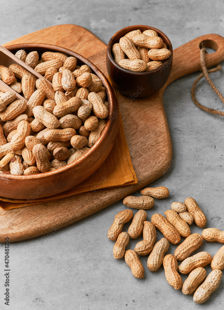 Image of wooden spoons with peanuts on a concrete surface Image of wooden spoons with peanuts on a concrete surface