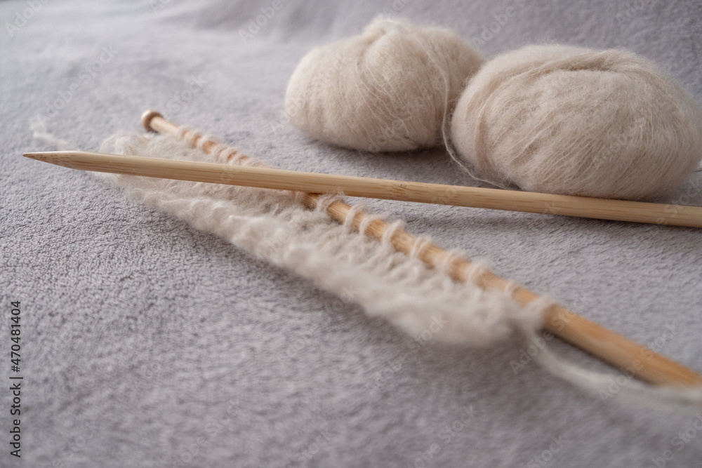 Incomplete knitting project with soft light alpaca silk yarn and bamboo knitting needles Incomplete knitting project with soft light alpaca silk yarn and bamboo knitting needles