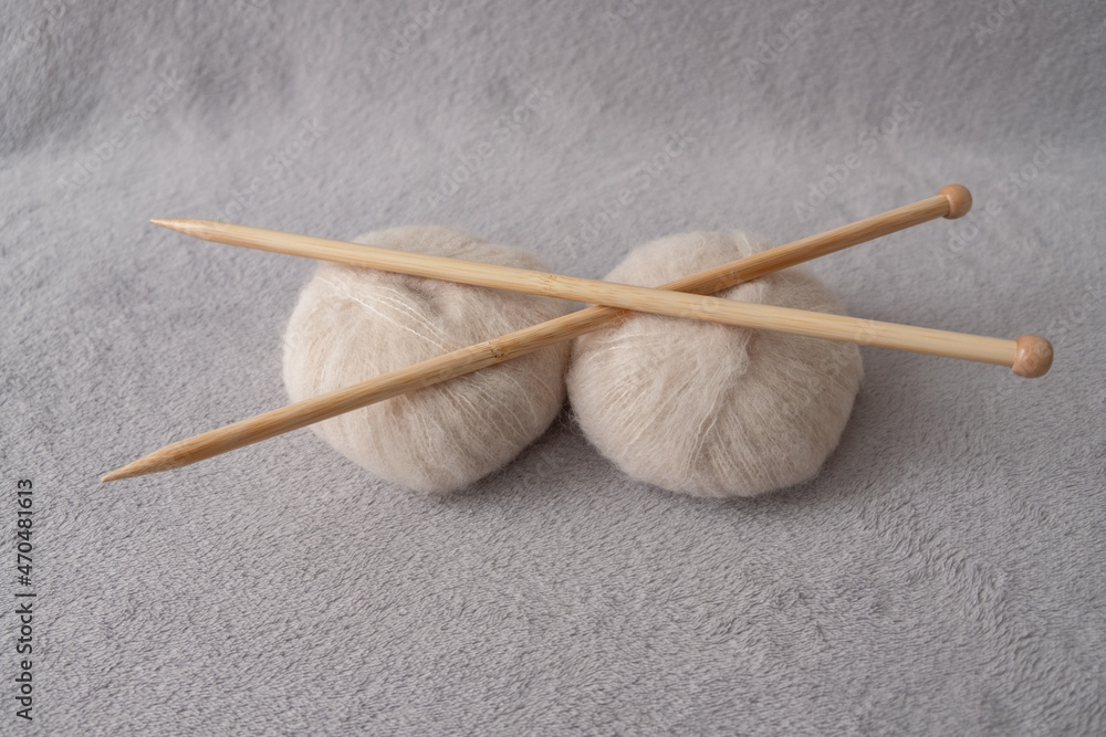 Two soft balls of alpaca silk yarn with two bamboo knitting needles Two soft balls of alpaca silk yarn with two bamboo knitting needles