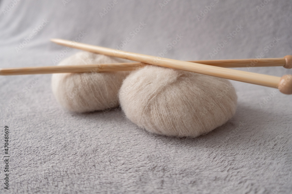 Two soft balls of alpaca silk yarn with two bamboo knitting needles Two soft balls of alpaca silk yarn with two bamboo knitting needles