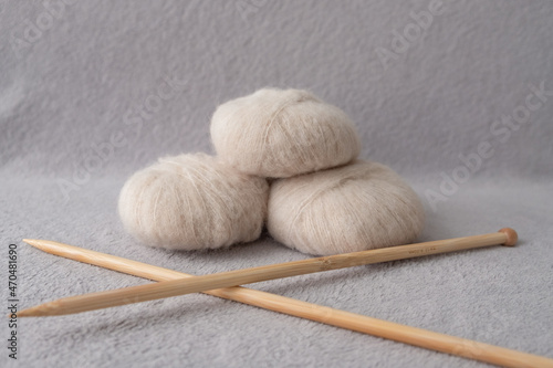 Three soft balls of alpaca silk yarn with two bamboo knitting needles