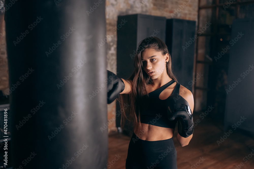 Fototapeta premium Young woman boxing workout at the gym