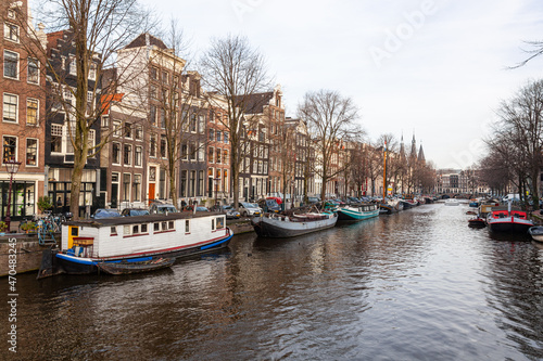 Canal in the old city of Amsterdam with traditional houseboats in a winter day, Netherlands. © Arkadii Shandarov