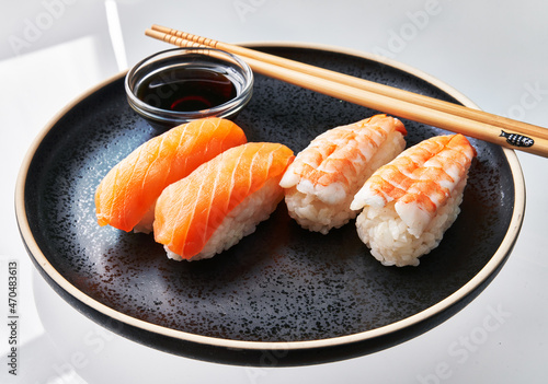 Plate of two shrimp nigiri sushi and two salomon nigiri sushi isolated on white background photo