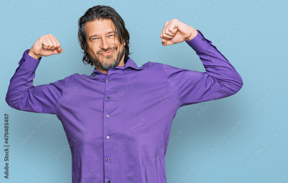 Middle age handsome man wearing business shirt showing arms muscles smiling proud. fitness concept. Middle age handsome man wearing business shirt showing arms muscles smiling proud. fitness concept.