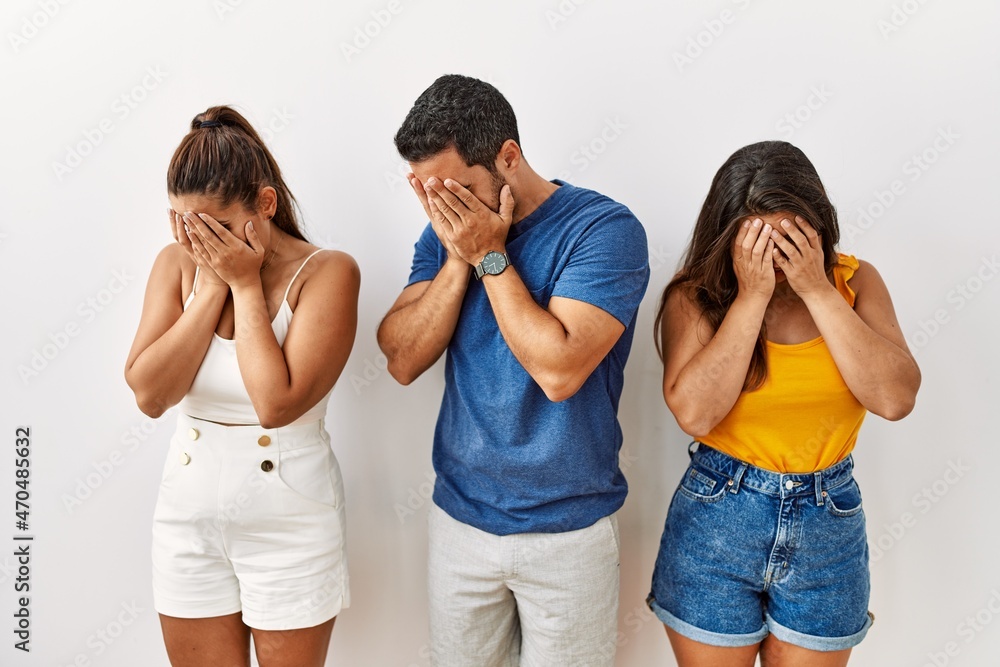 Group of young hispanic people standing over isolated background with sad expression covering face with hands while crying. depression concept. Group of young hispanic people standing over isolated background with sad expression covering face with hands while crying. depression concept.