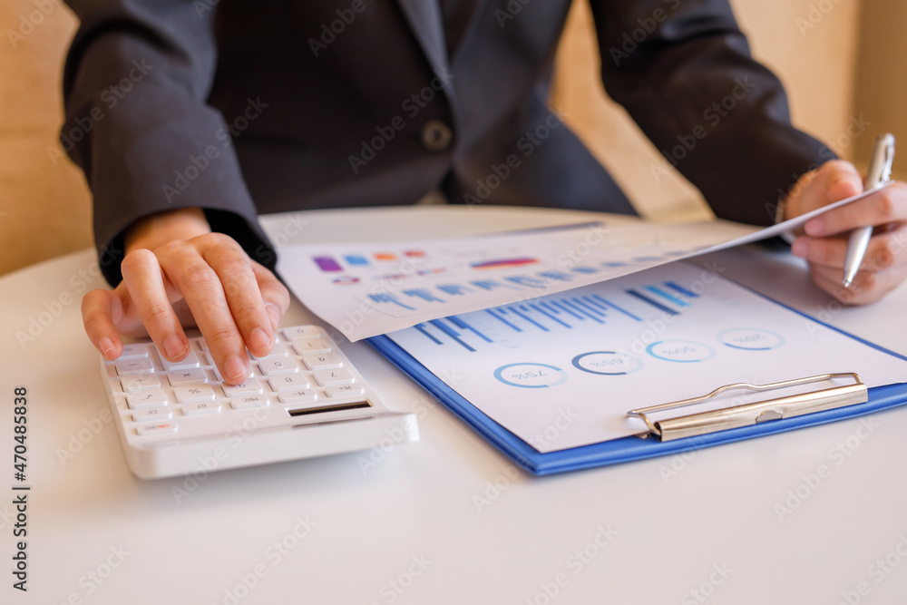 Close up of hand,Financial Businesswomen analyze the graph of the company's performance to create profits and growth, Market research reports and income statistics, Financial and Accounting concept. Close up of hand,Financial Businesswomen analyze the graph of the company's performance to create profits and growth, Market research reports and income statistics, Financial and Accounting concept.