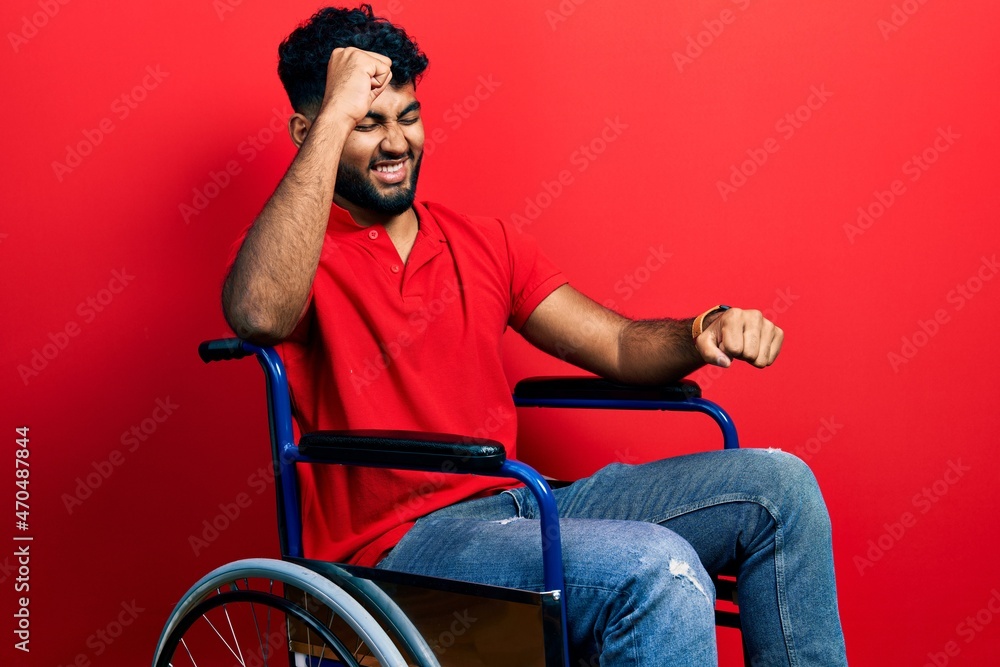 Arab man with beard sitting on wheelchair dancing happy and cheerful, smiling moving casual and confident listening to music Arab man with beard sitting on wheelchair dancing happy and cheerful, smiling moving casual and confident listening to music