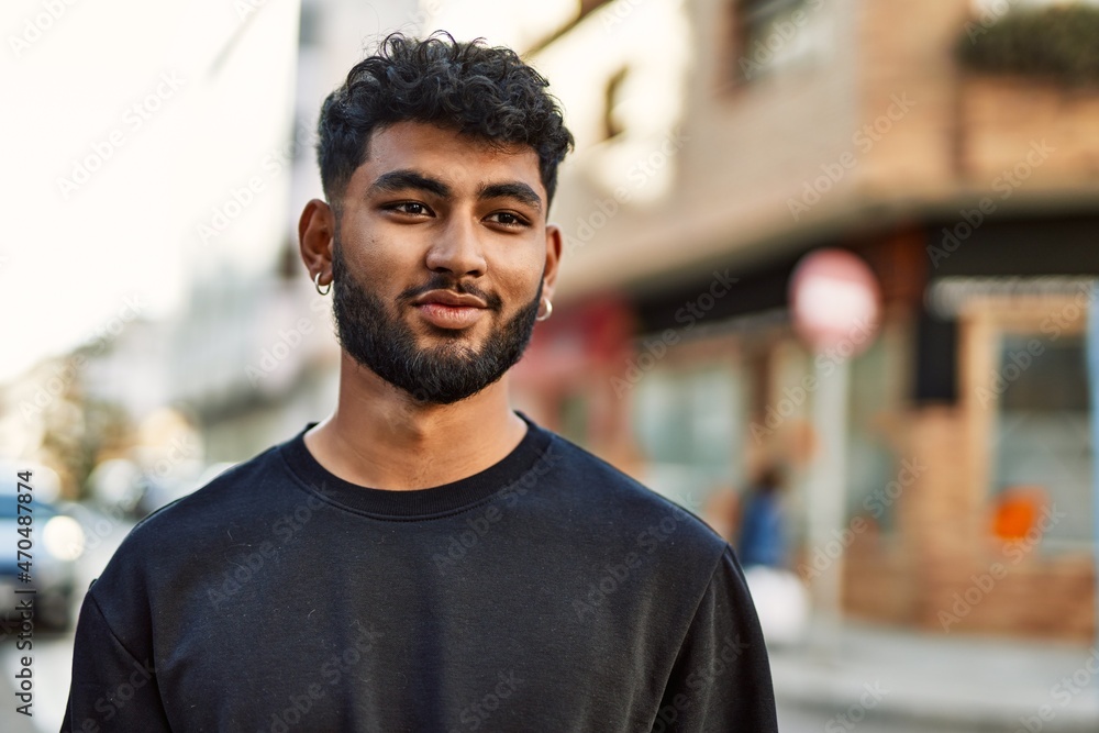 Fototapeta premium Young arab man smiling confident at street