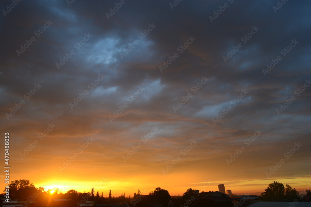 Sunset sky during overcast sky. Nature colors during sunset and silhouette of city