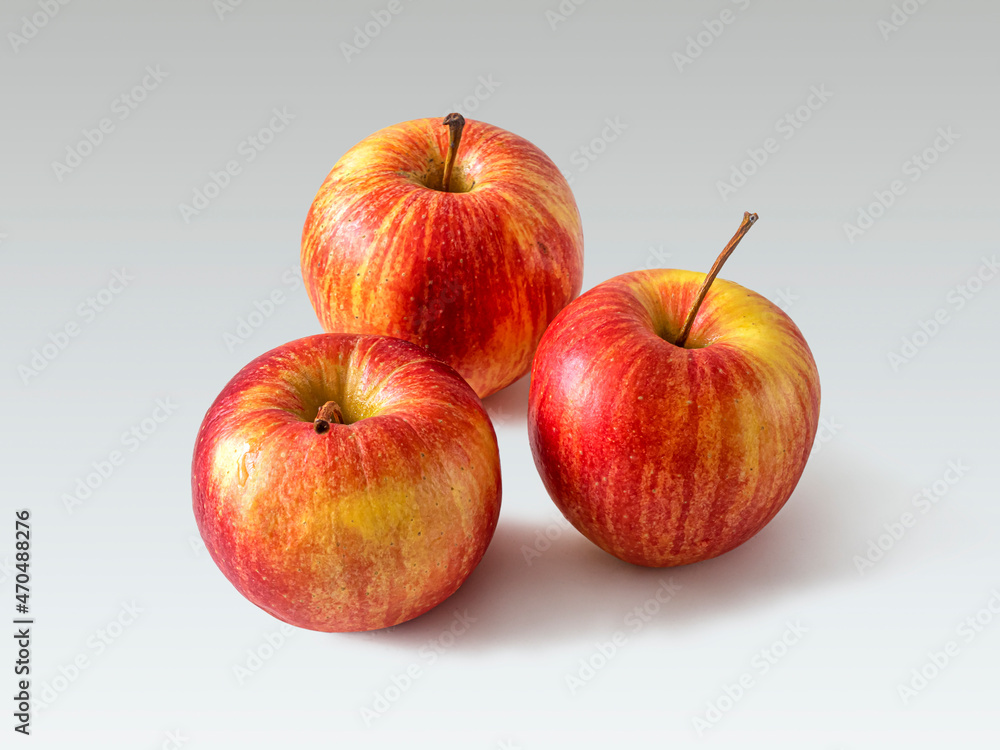 Three red-yellow apples on a light background Three red-yellow apples on a light background