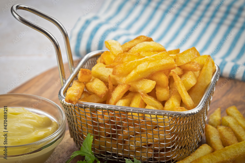 Frites en panier sur une table en bois Frites en panier sur une table en bois
