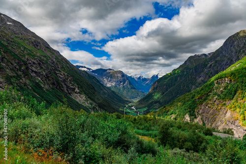 Scenic view from the road on a the valley between beautiful Norwegian mountains against  dramatic cloudy sky