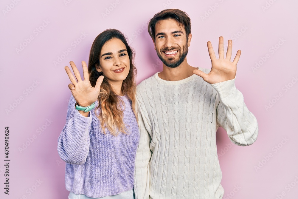 Young hispanic couple wearing casual clothes showing and pointing up with fingers number nine while smiling confident and happy. Young hispanic couple wearing casual clothes showing and pointing up with fingers number nine while smiling confident and happy.