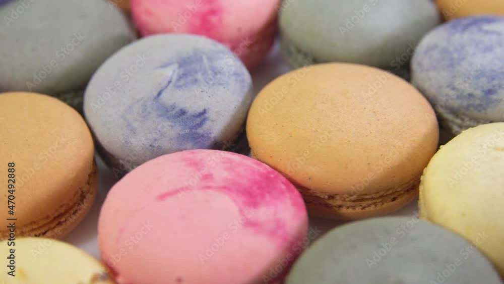 multicolored macarons, rotate on its axis on a white background. High quality 4k video multicolored macarons, rotate on its axis on a white background. High quality 4k video