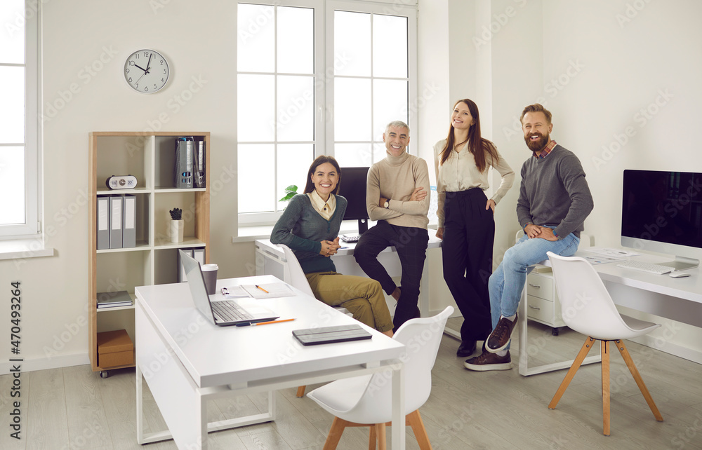 Portrait of happy businesspeople pose together in modern coworking office together. Smiling employees team show leadership and unity at workplace. Employment and recruitment at work space. Portrait of happy businesspeople pose together in modern coworking office together. Smiling employees team show leadership and unity at workplace. Employment and recruitment at work space.