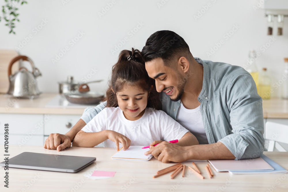 Young middle eastern father teaching his daughter alphabet Young middle eastern father teaching his daughter alphabet