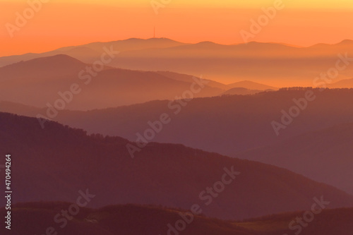 Abstract orange sunset over the evening mountains