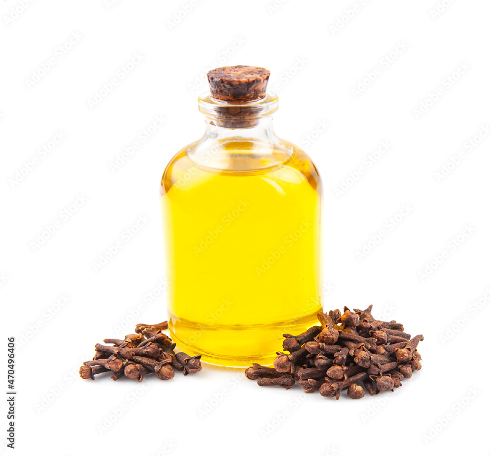 Clove essential oil in bottle and clove seed