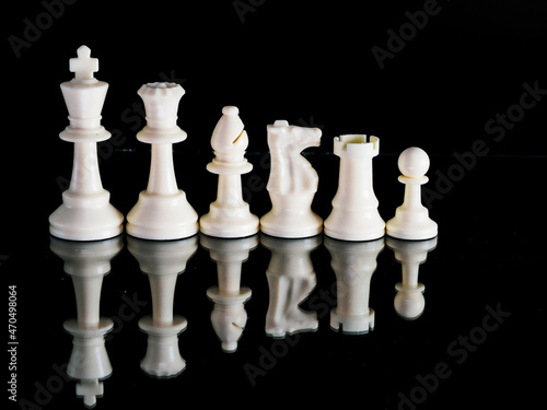 White Chess Pieces on a black background