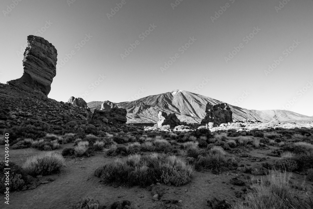 Black and white scenery of a barren volcanic landscape with sharp rocks ...