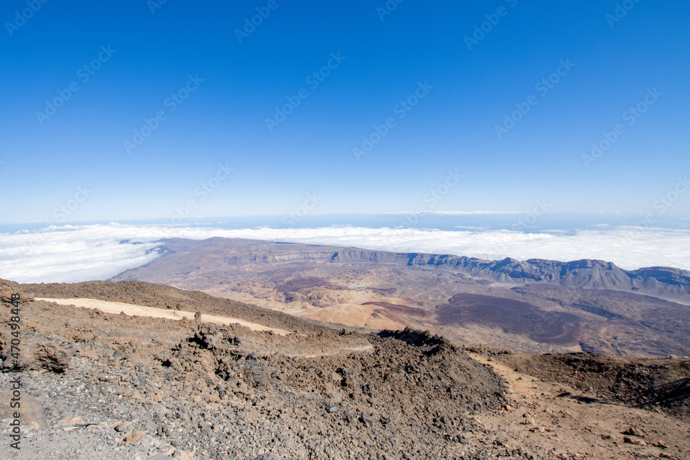 Hiking and trekking Teide volcano in Tenerife, Canary Islands. Scenic panorama of the tip of Teide (pico del teide) and rocky natural park. Natural park view and original landscape for adventures