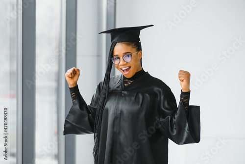 Closeup portrait of happy female student with certificate in college campus
