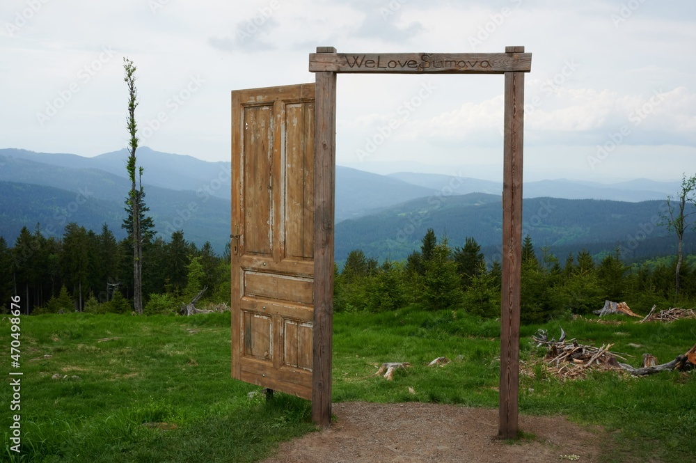 Wooden door in the mountains. Door to Šumava. We love Šumava. Wooden door in the mountains. Door to Šumava. We love Šumava.