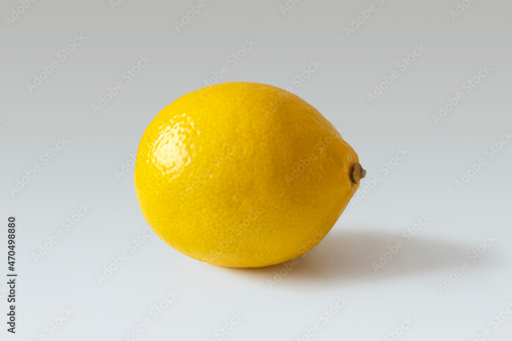 Bright yellow lemon on a light gray background