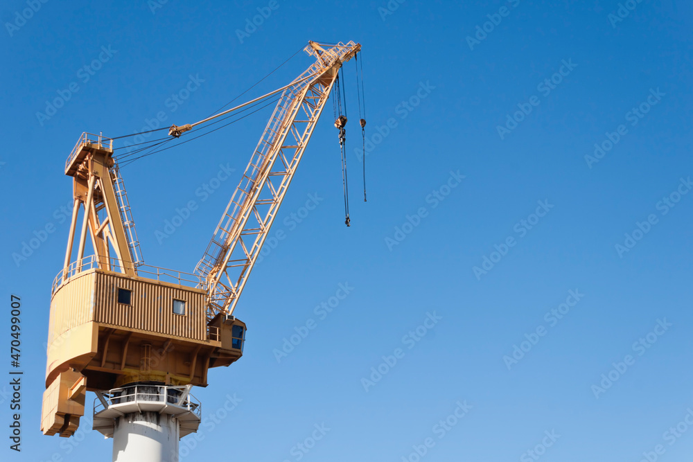 Yellow shipyard crane on blue sky background Yellow shipyard crane on blue sky background