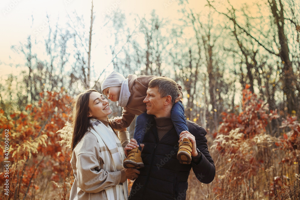 family with a small child walking in the park family with a small child walking in the park