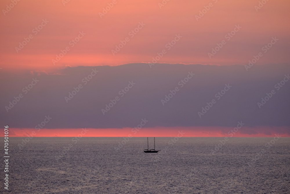 View on the sea and a boat on the sunset, location Fuerteventura, Spain.