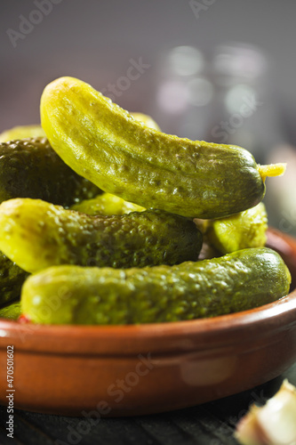 Pickled gherkins. Salted Cucumbers on a dark rustic background  selective focus