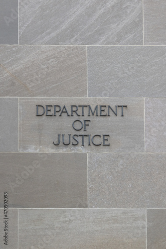 Department of justice sign on stone wall in Washington DC, USA photo