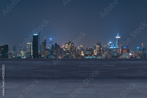 Panoramic Bangkok skyline view  concrete observatory deck on rooftop  night time. Asian corporate and residential lifestyle. Financial city downtown  real estate. Product display mockup empty roof