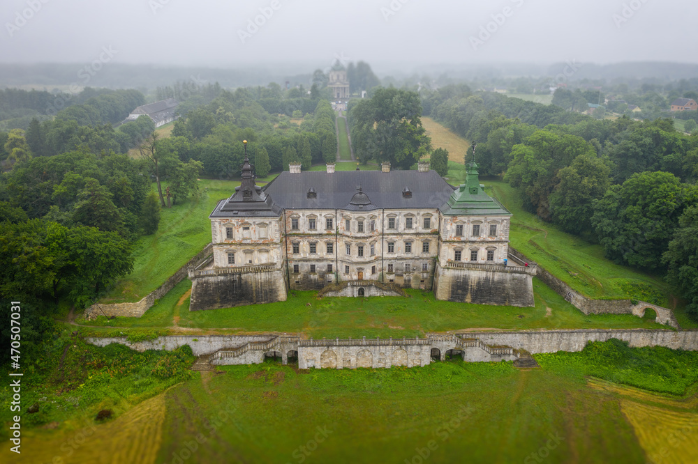 Old castle in Pidhirci. Famous ukranian sightseeing. Church of St. Joseph in the background. Palace ensemble. Western Ukraine.