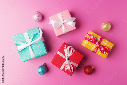 Various gift boxes and Christmas decoration on pink background