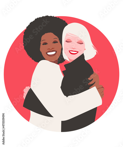 Young and smiling happy embracing women. Interracial friendship. Diversity
