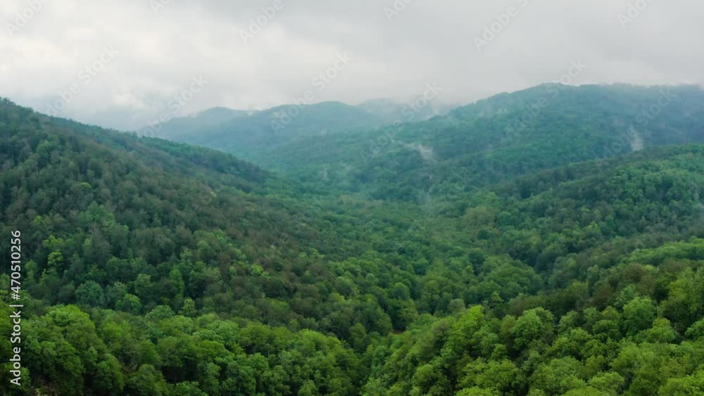 Caucasus Mountains, Akhun mountain range. Navalishinsky Canyon (White rocks). The valley of the Bolshaya Khosta River in fog. Aerial view. Caucasus Mountains, Akhun mountain range. Navalishinsky Canyon (White rocks). The valley of the Bolshaya Khosta River in fog. Aerial view.