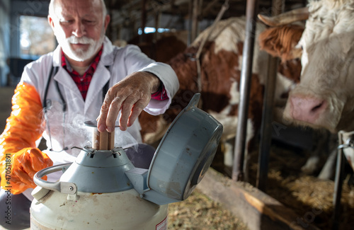 Veterinarian holding semen for cows artificial insemination